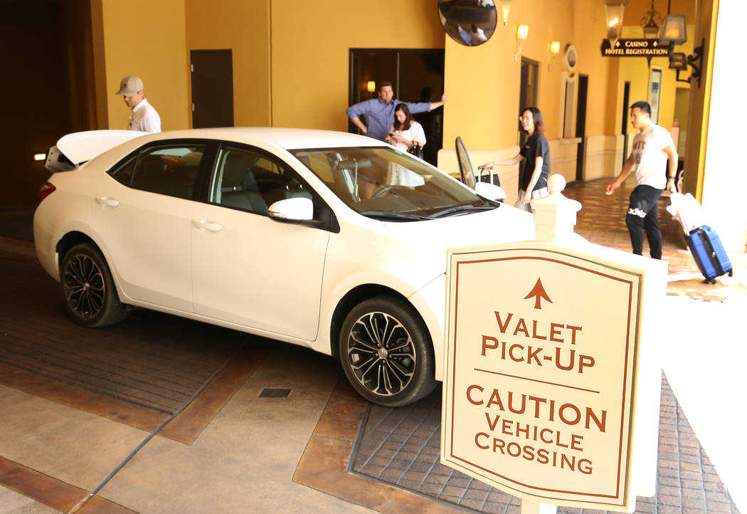 Hotel guests at Wynn Las Vegas prepare to load their luggage into their car at valet parking pi ...