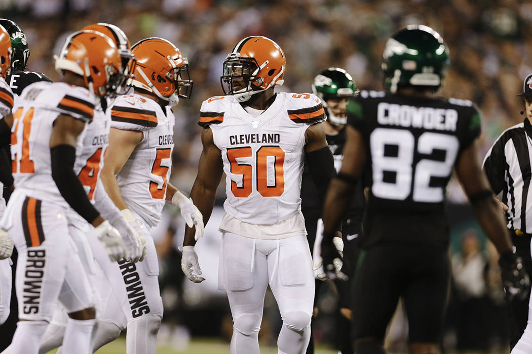 Cleveland Browns defensive end Chris Smith (50) stands with teammates during the second half of ...