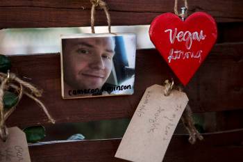 A picture of Cameron Robinson, a victim in Sunday's shooting, hangs on the "Remembrance Wall" a ...