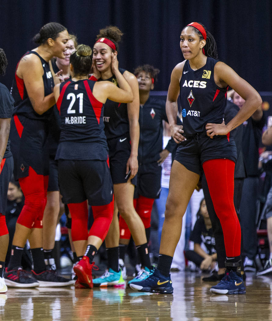 Teammates congratulate Las Vegas Aces forward Dearica Hamby (5) after making a late-game three- ...