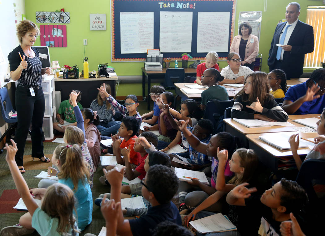 Triggs Elementary Principal Sheila Cooper and Superintendent Dr. Jesus Jara, right rear, observ ...