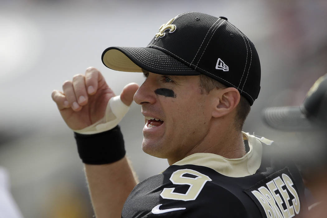 New Orleans Saints quarterback Drew Brees watches from the sidelines after getting hurt during ...