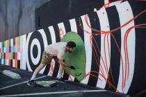 Artist Eric Vozzola works on his mural "An Allegory of Natural Beauty" for the Life is Beautifu ...
