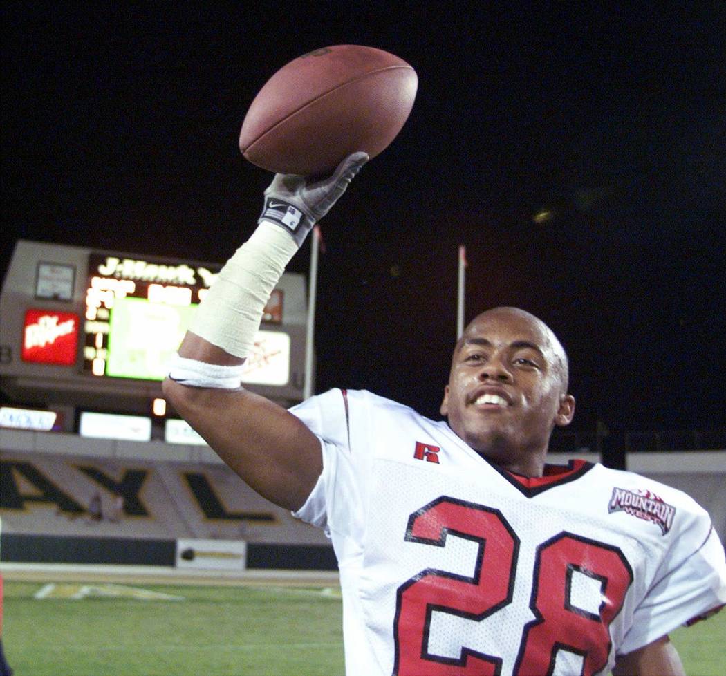 UNLV defensive back Kevin Thomas celebrates following the game with the game ball after picking ...