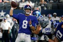 New York Giants quarterback Daniel Jones (8) throws a pass under pressure from Dallas Cowboys d ...