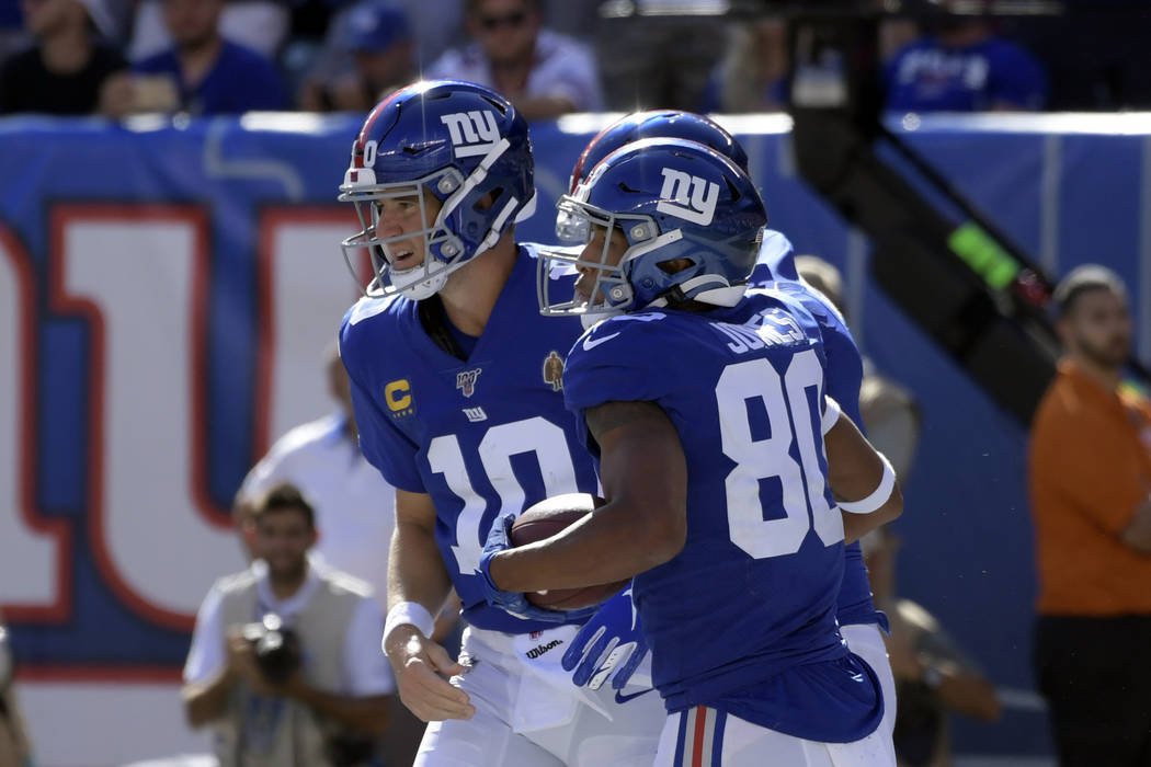 New York Giants TJ Jones, right, celebrates his touchdown with quarterback Eli Manning during t ...