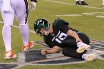New York Jets quarterback Trevor Siemian (19) grabs his leg after being hurt during the first h ...