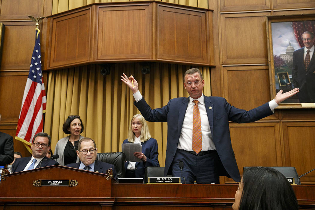 Rep. Doug Collins, R-Ga., the ranking member on the House Judiciary Committee, right, throws hi ...