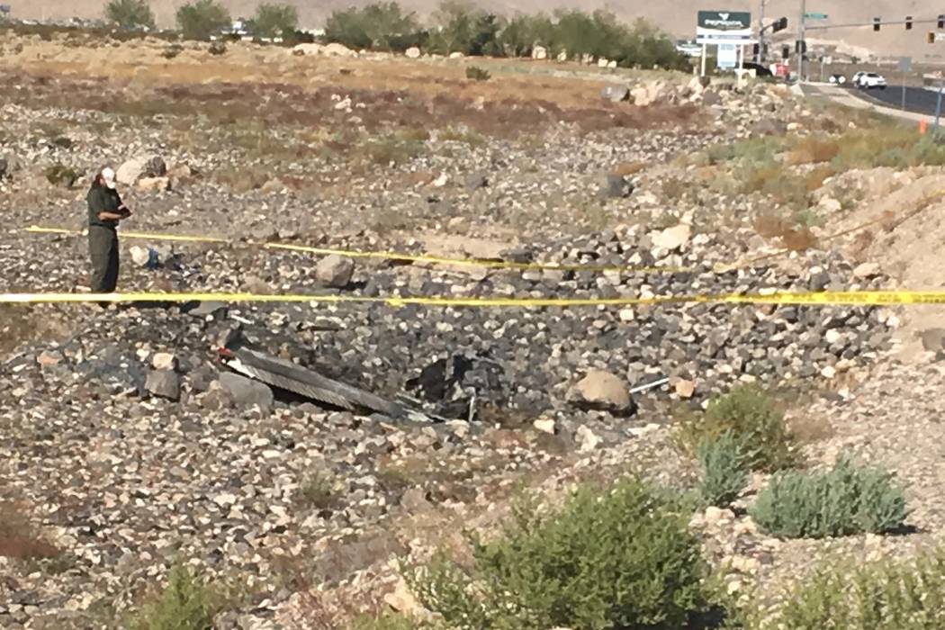 Investigators on scene after a small propeller plane crashed near Henderson Executive Airport o ...