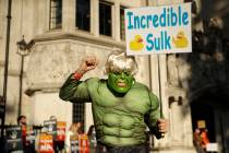 Protesters hold banners outside the Supreme Court in London, Tuesday Sept. 17, 2019. The Suprem ...