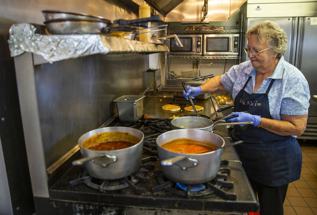 Pat Travis of the Little A'Le'Inn cooks breakfast for customers and is preparing as much as pos ...