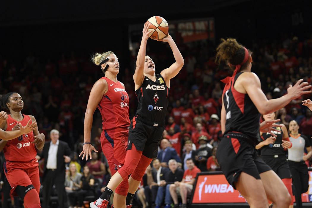 Las Vegas Aces guard Kelsey Plum throws up a shot in front of Washington Mystics forward Elena ...