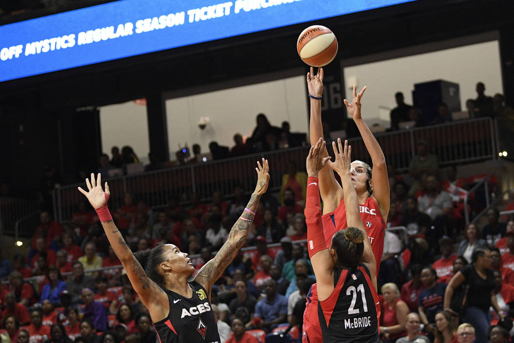 Washington Mystics forward Elena Delle Donne, back, shoots over Las Vegas Aces guard Kayla McBr ...