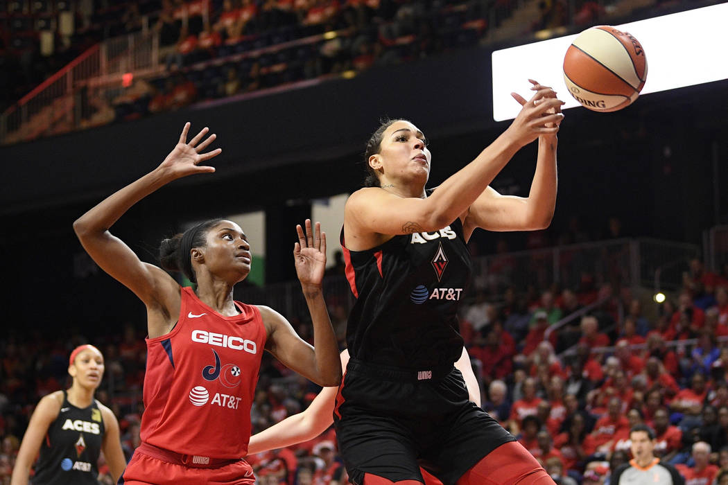 Las Vegas Aces center Liz Cambage, right, loses the ball as Washington Mystics forward LaToya S ...