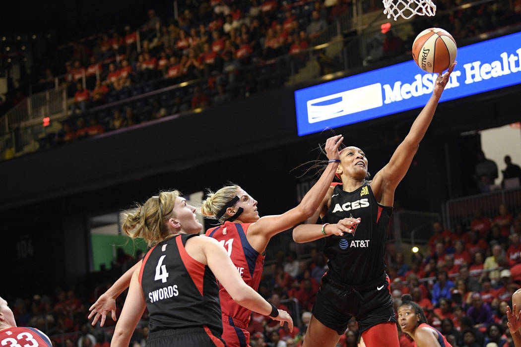 Las Vegas Aces center A'ja Wilson, right, goes to the basket against Washington Mystics forward ...