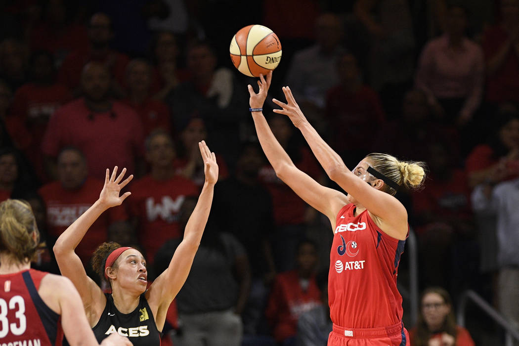 Washington Mystics forward Elena Delle Donne, right, shoots against Las Vegas Aces forward Dear ...