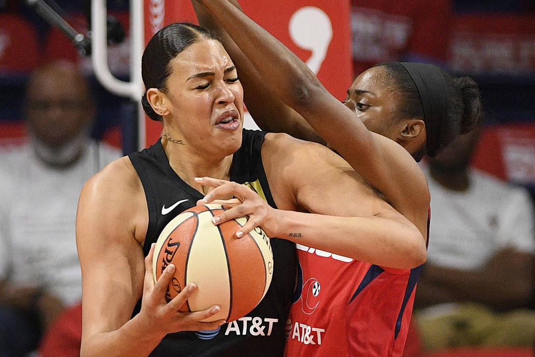 Washington Mystics forward LaToya Sanders, right, guards Las Vegas Aces center Liz Cambage duri ...