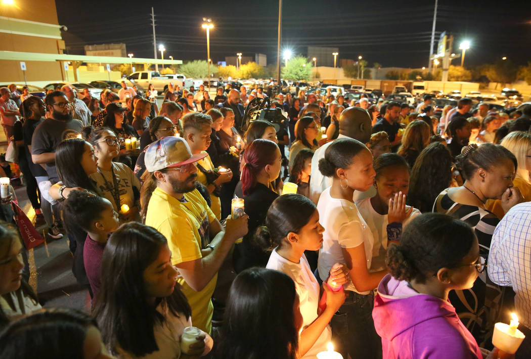 People gather at the Sobe Ice Arena during a candlelight vigil for Mark Garcia and his daughter ...