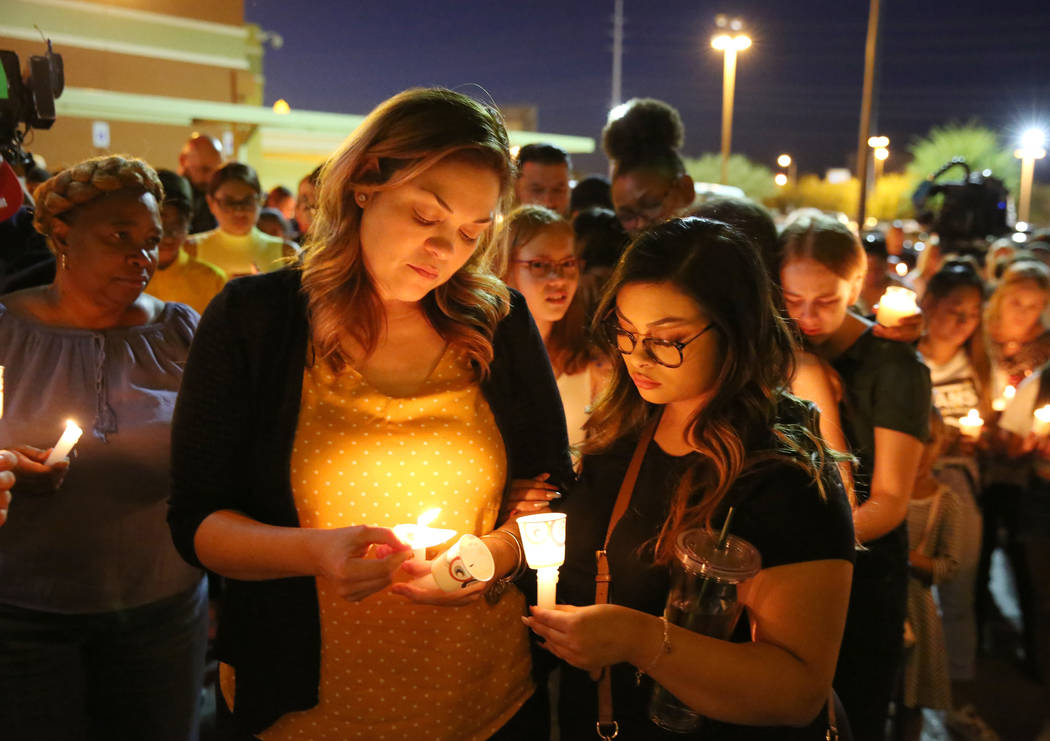 Veronica Robles, left, sister of Mark Garcia, and her daughter Jazmyn, 17, attend a candlelight ...
