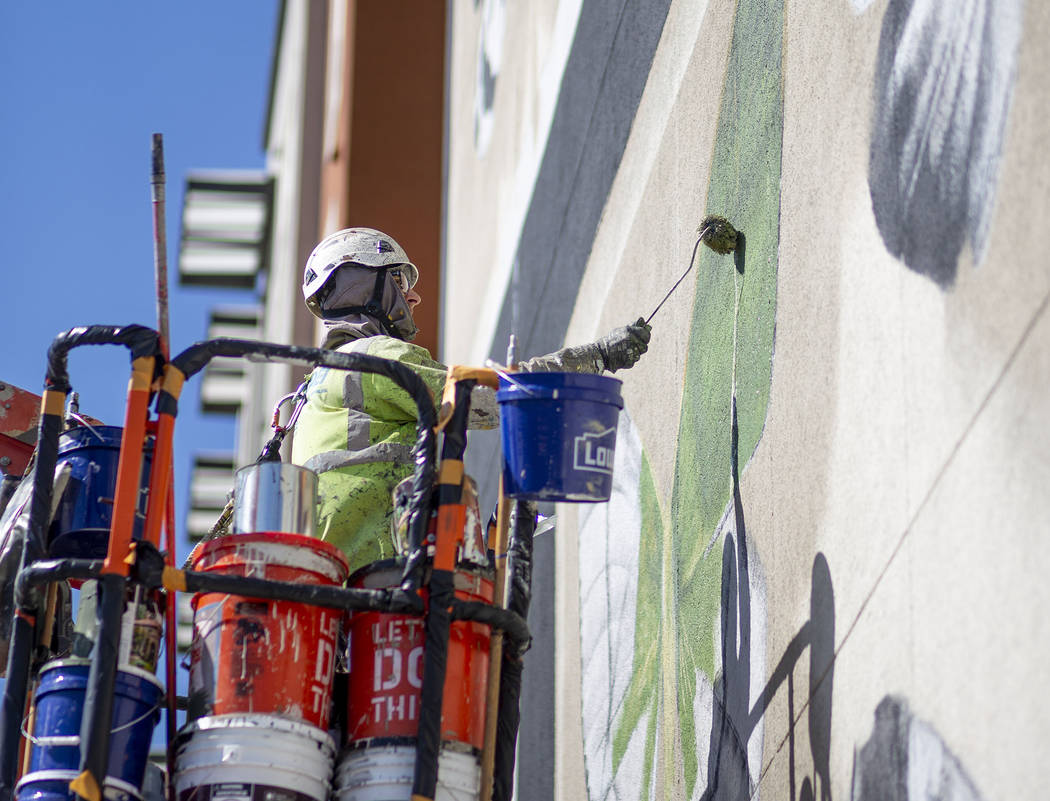 French painter Mantra works on his mural in preparation for Life is Beautiful music festival in ...