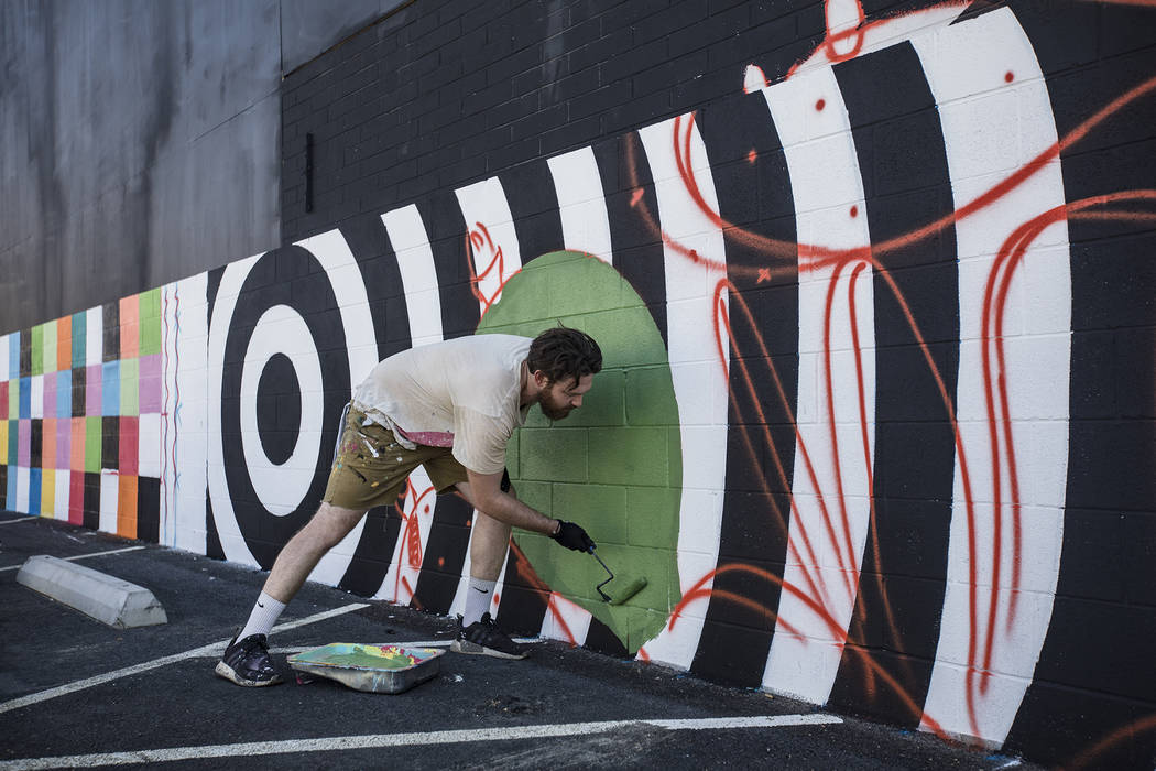 Artist Eric Vozzola works on his mural "An Allegory of Natural Beauty" for the Life i ...