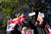 Demonstrators hold placards and flags outside the Supreme Court in London, Wednesday, Sept. 18, ...