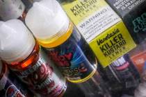 In this Sept. 16, 2019 file photo flavored vaping solutions are shown in a window display at a ...
