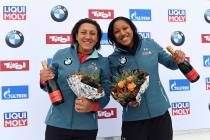 Elana Meyers Taylor, right and Sylvia Hoffmann from the United States celebrate their third pla ...