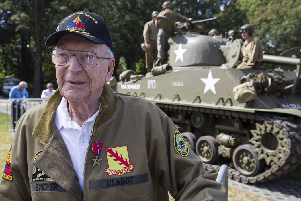 World War II veteran Clarence Smoyer, 96, poses for a picture in front of a Sherman tank after ...