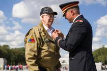World War II veteran Clarence Smoyer, 96, receives the Bronze Star from U.S. Army Maj. Peter Se ...