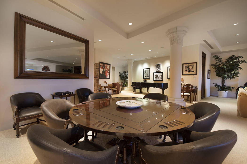 Synergy Sotheby’s International Realty The game room in this 1980s mansion is adorned with ph ...