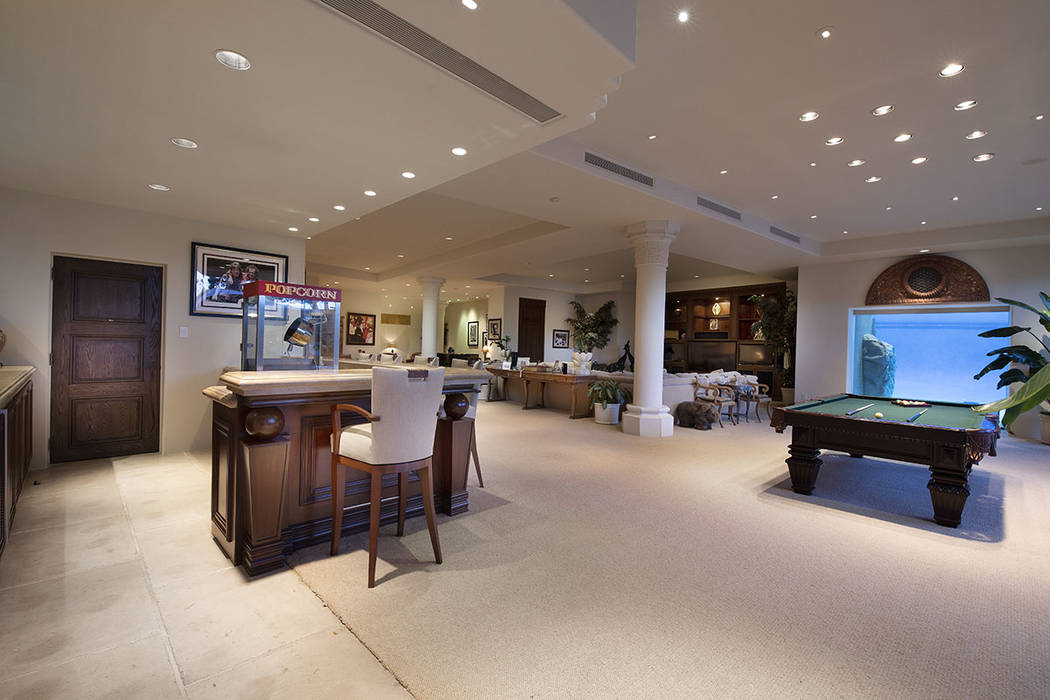The game room has a bar, pool and poker tables. (Synergy Sotheby’s International Realty)