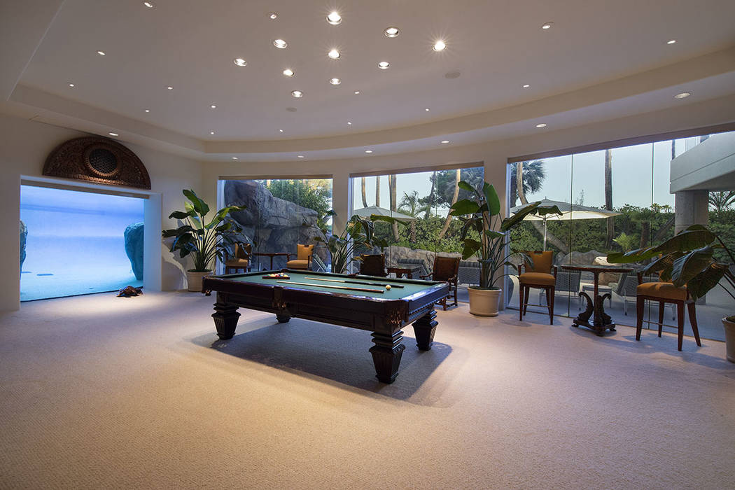 The game room features a window that has an underwater view of the pool. (Synergy Sotheby’s I ...