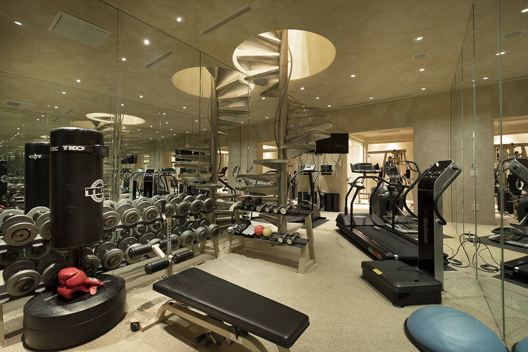 The gym has stairs leading to a bath. (Synergy Sotheby’s International Realty)