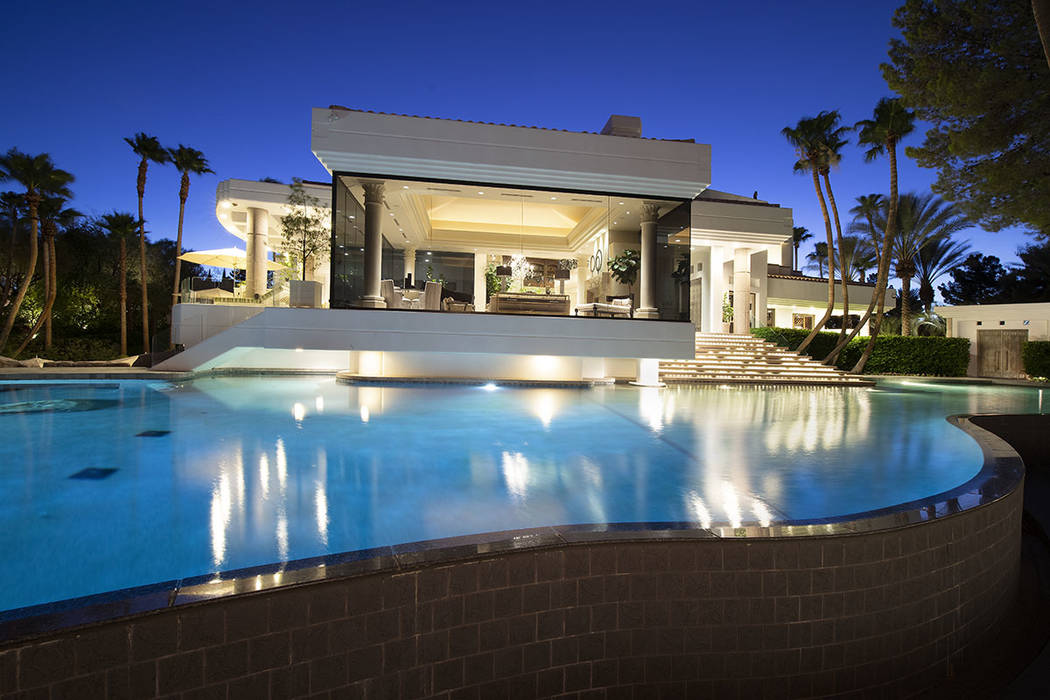 The large pool flows to the side of the home. (Synergy Sotheby’s International Realty)