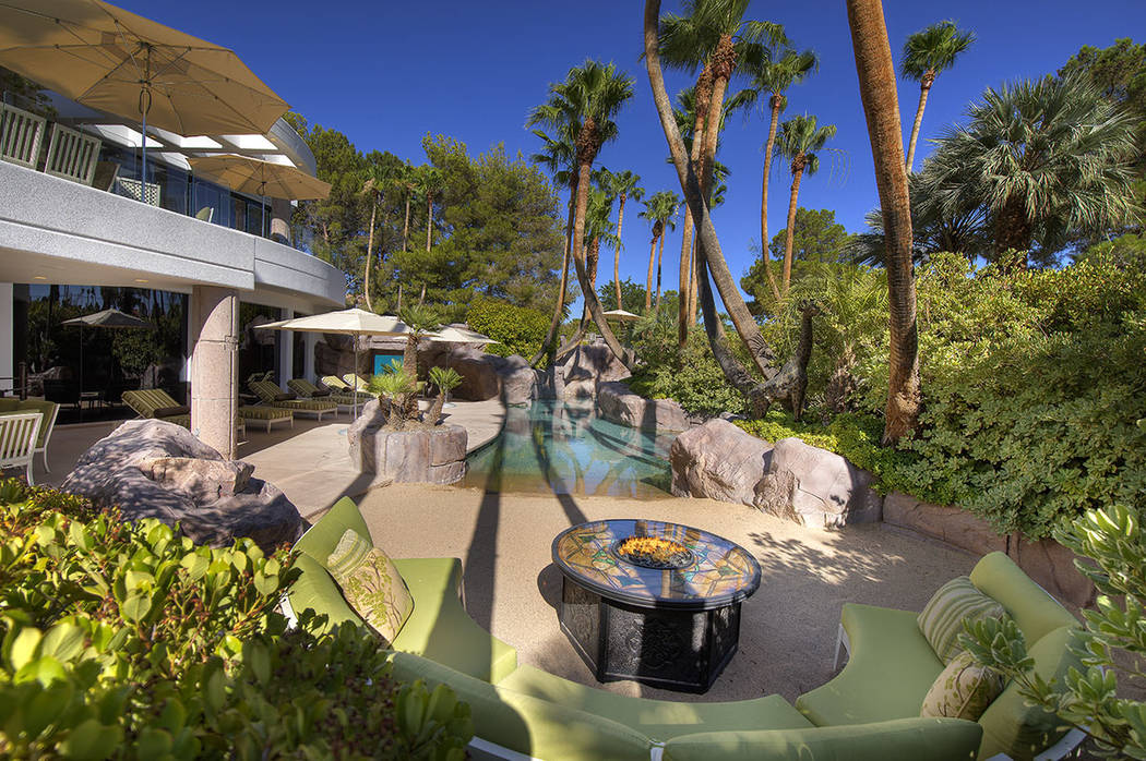 The pool area has a beach and fire pit. (Synergy Sotheby’s International Realty)