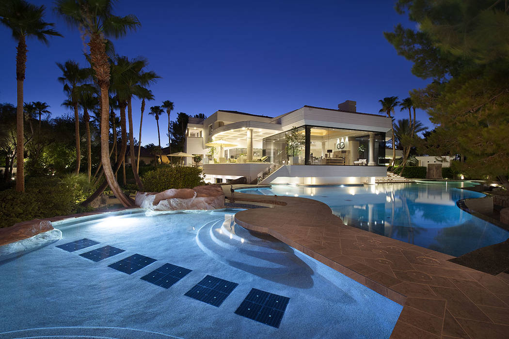 The estate features a large pool with a walkway. (Synergy Sotheby’s International Realty)