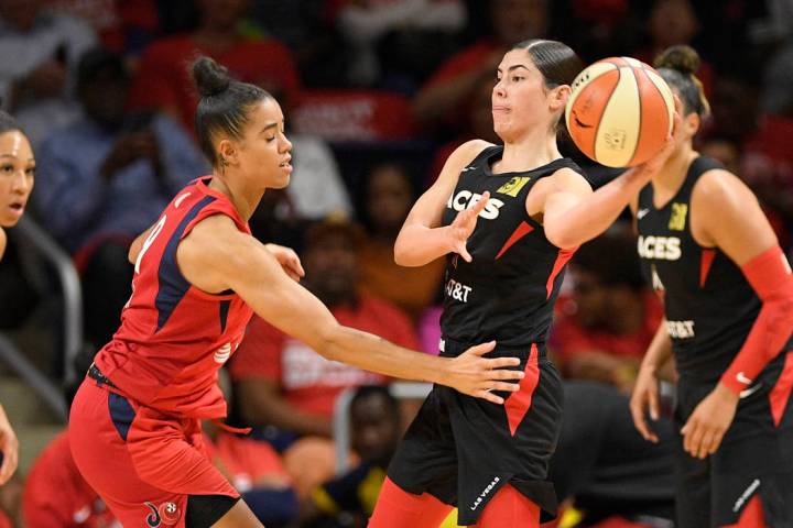 Las Vegas Aces guard Kelsey Plum, right, looks to pass the ball as Washington Mystics guard Nat ...