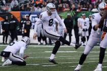 Oakland Raiders kicker Daniel Carlson (8) kicks a field goal with punter Johnny Townsend (5) ho ...