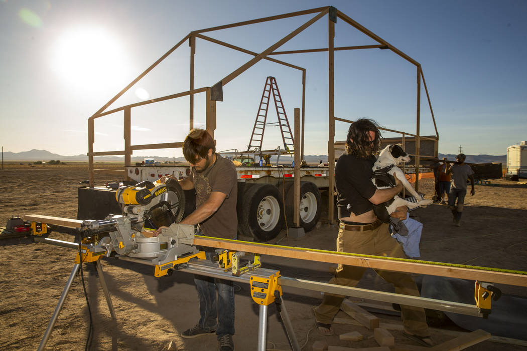 Jesse Morrow, left, works with others to construct the main stage for the upcoming Alienstock f ...