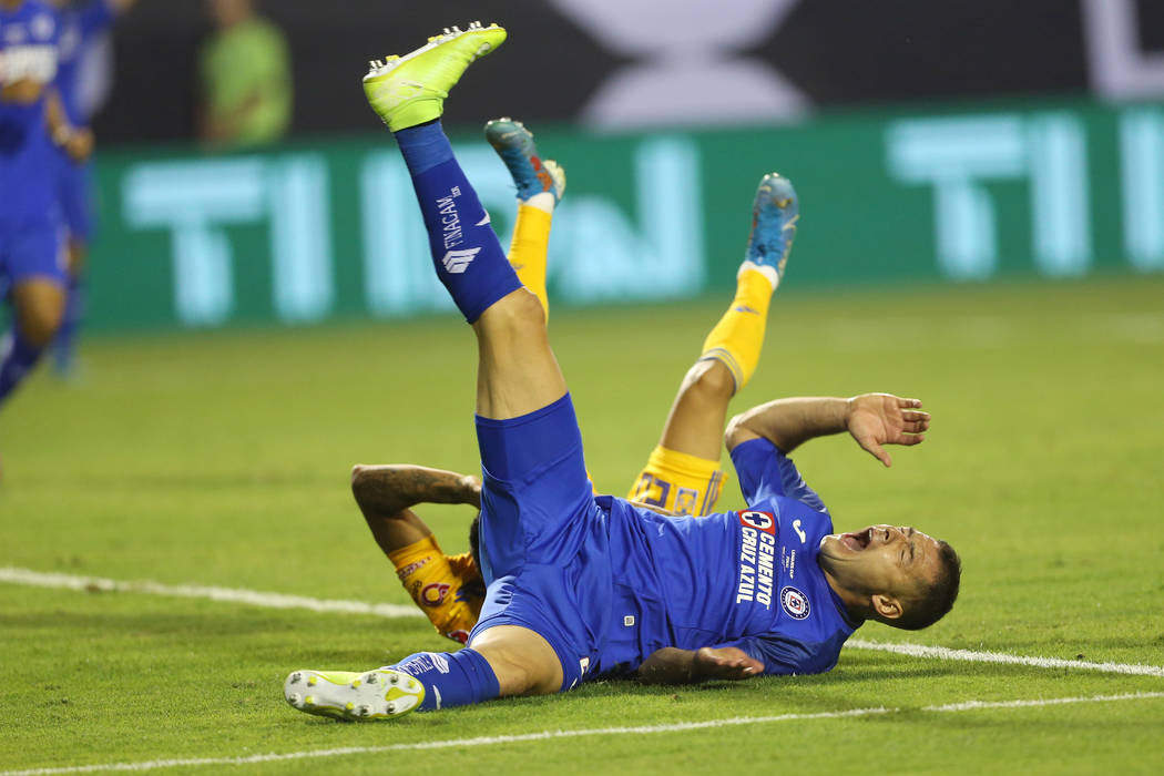 Cruz Azul's Pablo Aguilar (23) falls to the ground after making contact with Tigres' Javier Aqu ...
