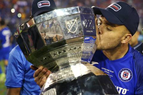 Cruz Azul's Jonathan Rodriguez (21) kisses the trophy after winning 2-1 against Tigres in the L ...