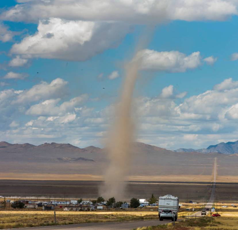 A large dust devil kicks up debris as it passes through Rachel off state Route 375 as preparati ...