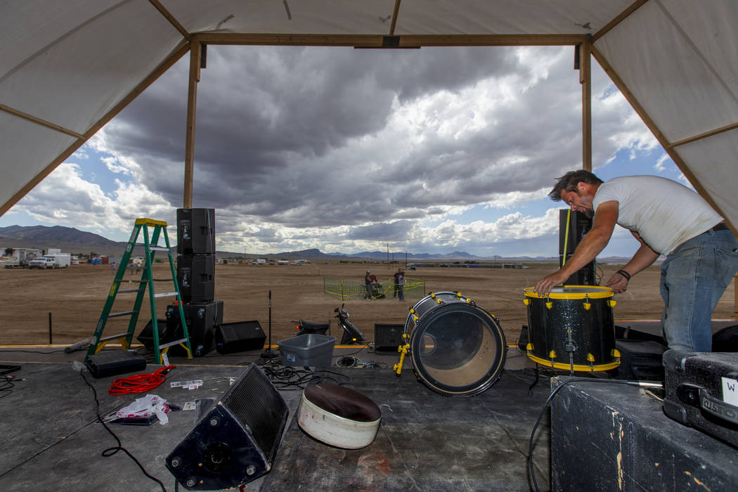 Jeremy Morrow of Wily Savage from Hollywood begins to set up his drums on the new main stage wi ...
