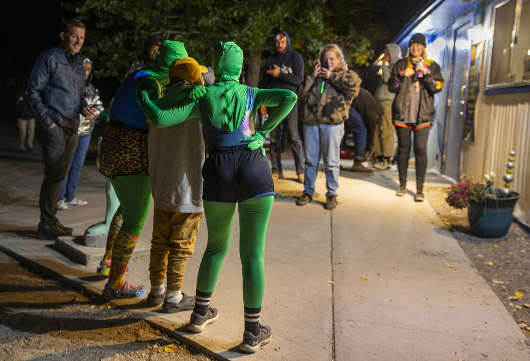 Festivalgoers hang out with some aliens at the Little A'Le'Inn late on the first night of Alien ...