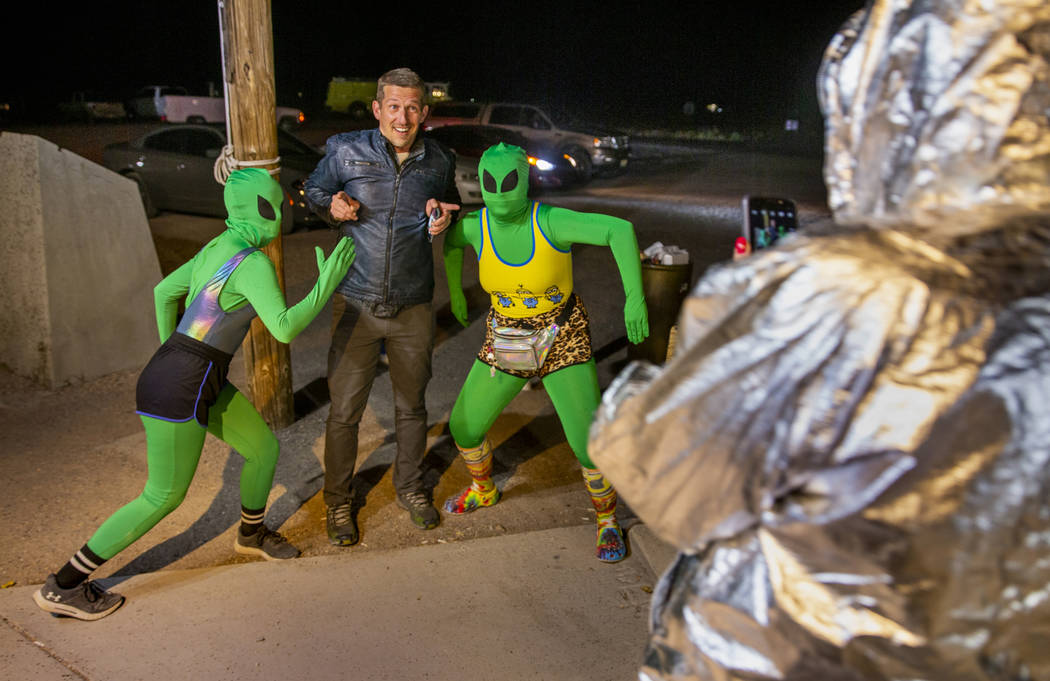 Festivalgoers hang out with some aliens at the Little A'Le'Inn late on the first night of Alien ...