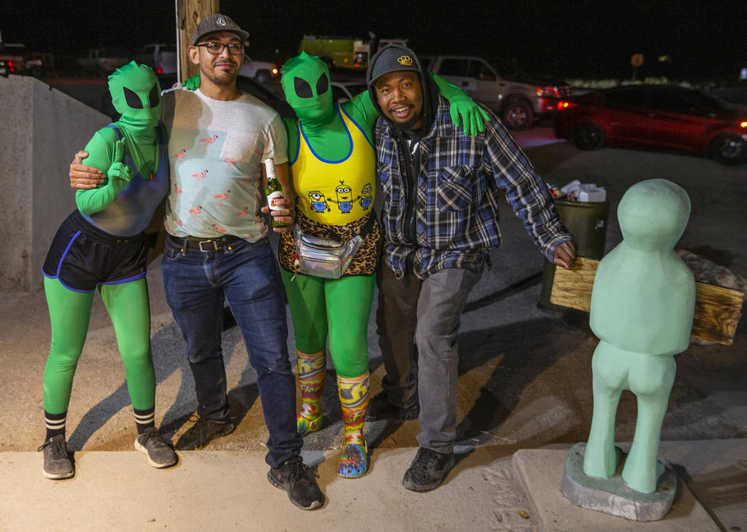 Festivalgoers Michael Solarzano, left, and James Bivens hang out with some aliens at the Little ...