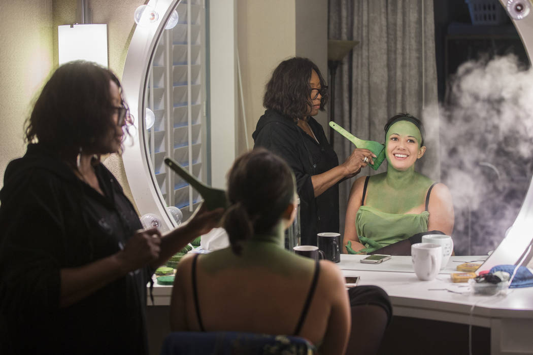 Mariand Torres, right, who plays Elphaba in "Wicked," gets her makeup done by makeup supervisor ...