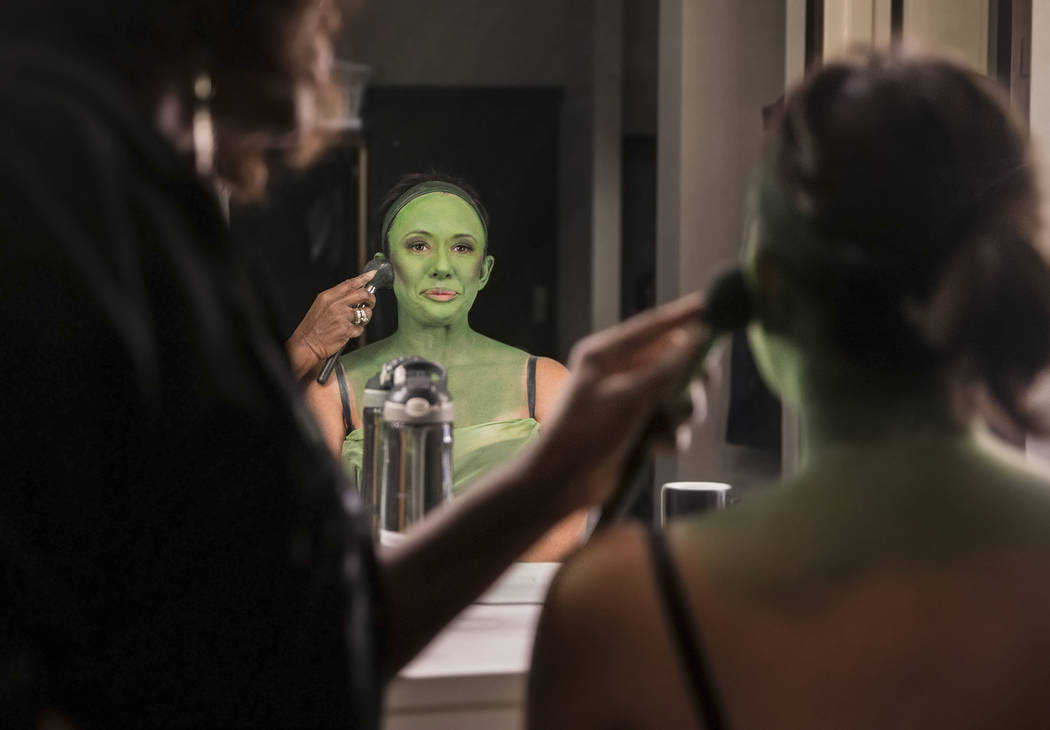Mariand Torres, right, who plays Elphaba in "Wicked," gets her makeup done by makeup supervisor ...