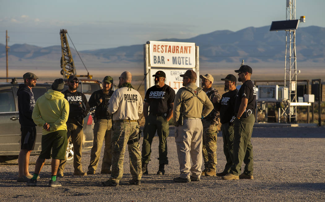 Law enforcement officers gather outside the Little A'Le'Inn, which closed Thursday before the s ...
